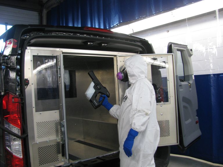 Electrostatic spraying of disinfectant inside van