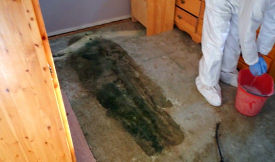 Cleaning outline of deceased body on carpet