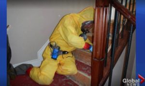 Hazmat technician in PPE cleaning stairs