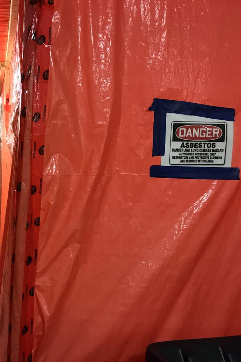 Orange plastic decontamination area in hotel hallway