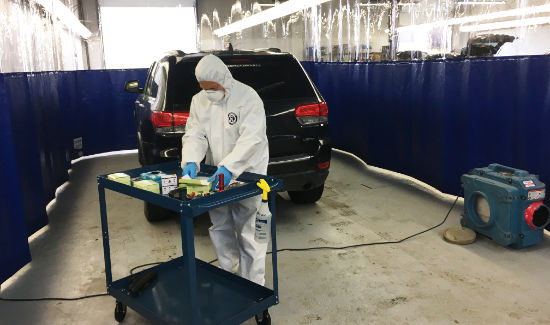 Hazmat technician testing samples from vehicle